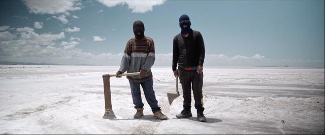 Nico and his co-worker holding axe at Uyuni Salt Flats in bolivia