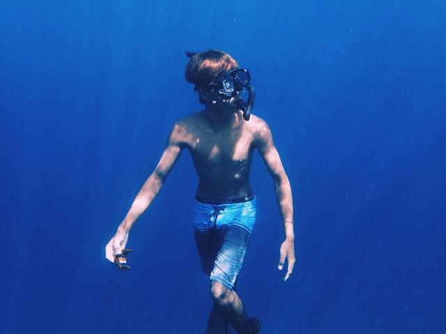 Boy diving underwater