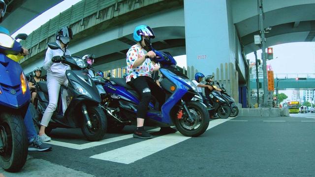 Crowd of Taiwanese motorbikers waiting on the crosswalk