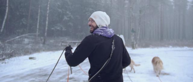 Dogwalker Matt Hein with dogs in winter Oslo woods