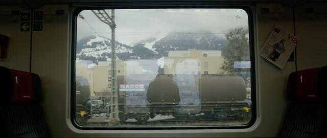 Erik Nylander's reflection in the window of a European train