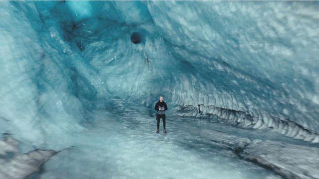 Garðar Ólafsson standing in a ice cave on Iceland