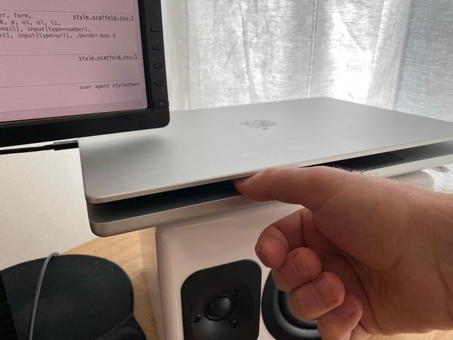 thumb in MacBook Pro keeping it open